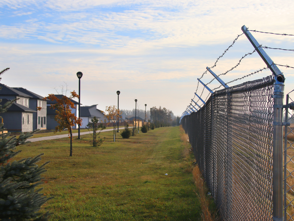 Barbed wire added to fence near Hampton Village without a permit